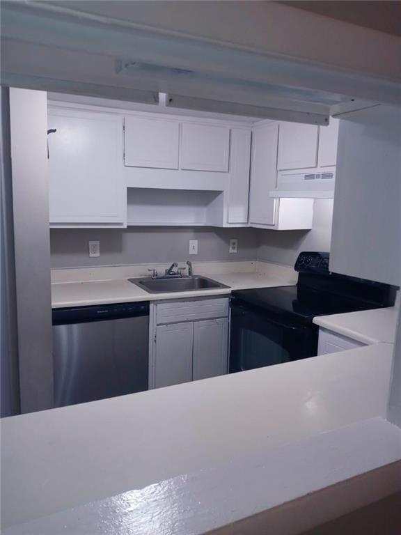 a kitchen with granite countertop white cabinets and stainless steel appliances