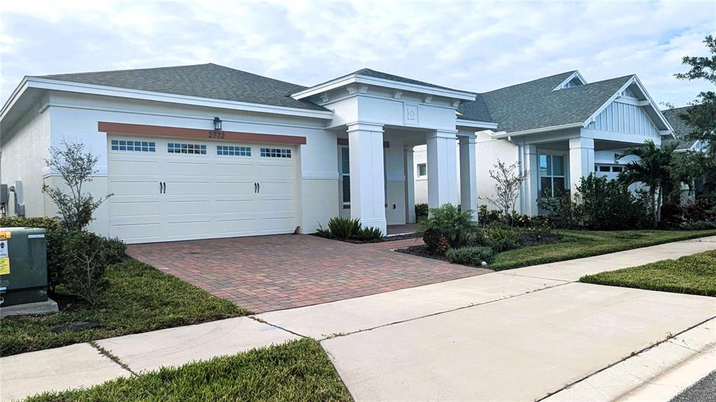 a front view of a house with a yard and garage