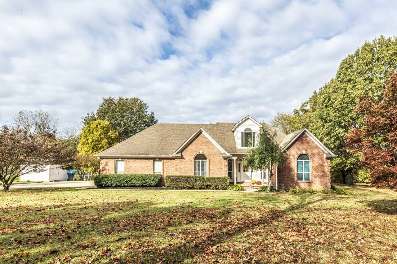 View of property with a front yard