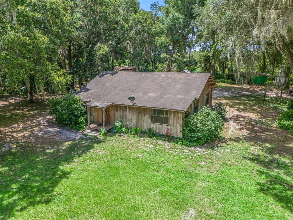 an aerial view of a house with yard and outdoor seating