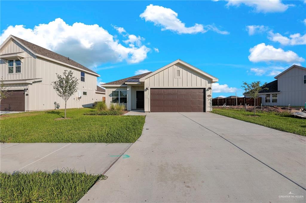 View of front of home with a garage and a front yard