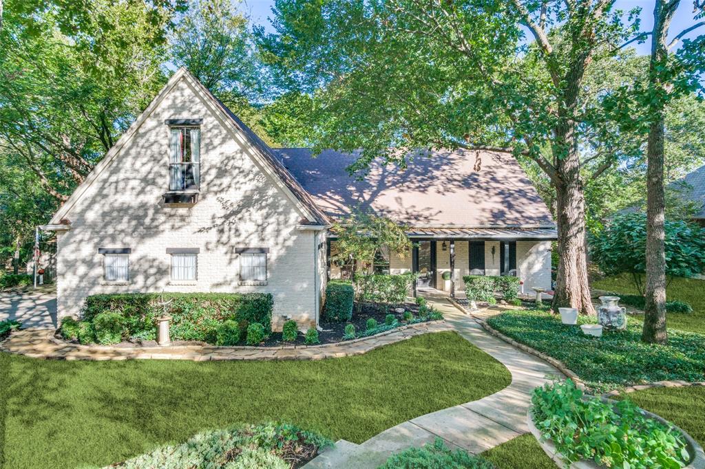 a view of a house with a yard patio and a garden