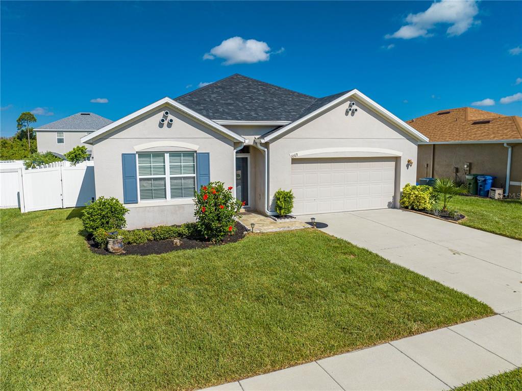 a front view of a house with a yard and garage