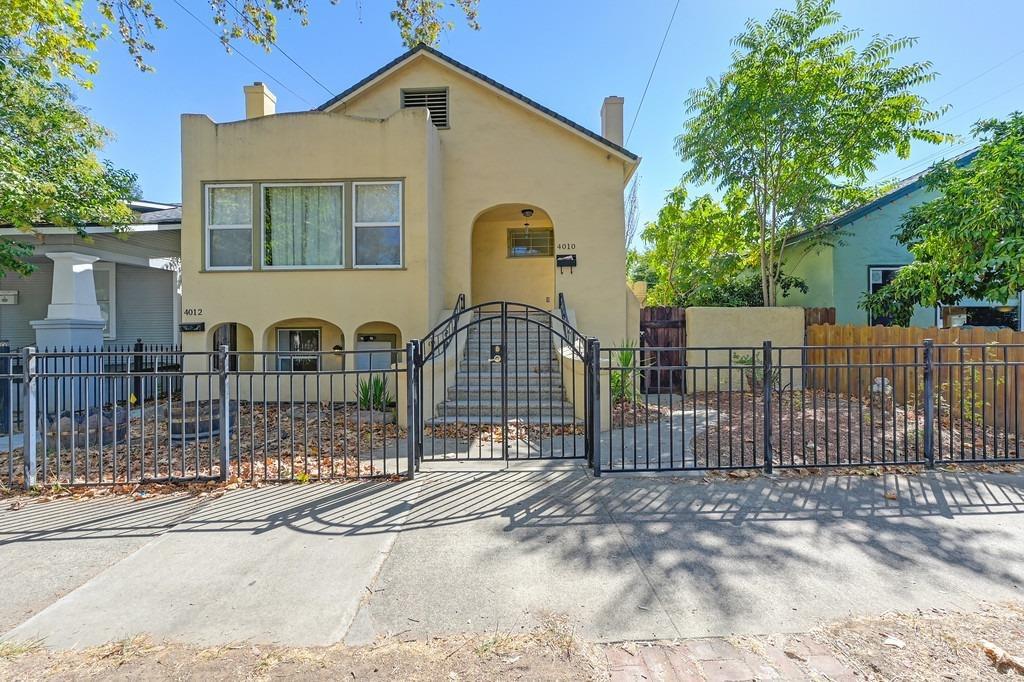 a front view of a house with iron fence