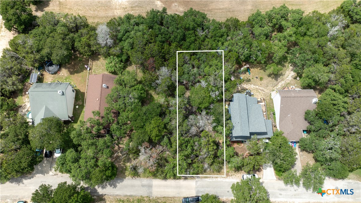 an aerial view of a house with yard