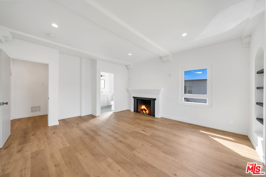 a view of empty room with fireplace