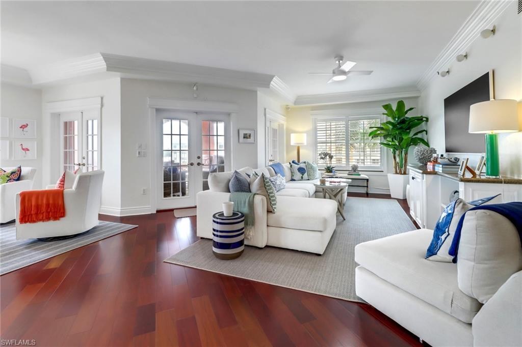 a living room with fireplace furniture and wooden floor