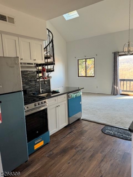 a kitchen with stainless steel appliances granite countertop a stove and a sink