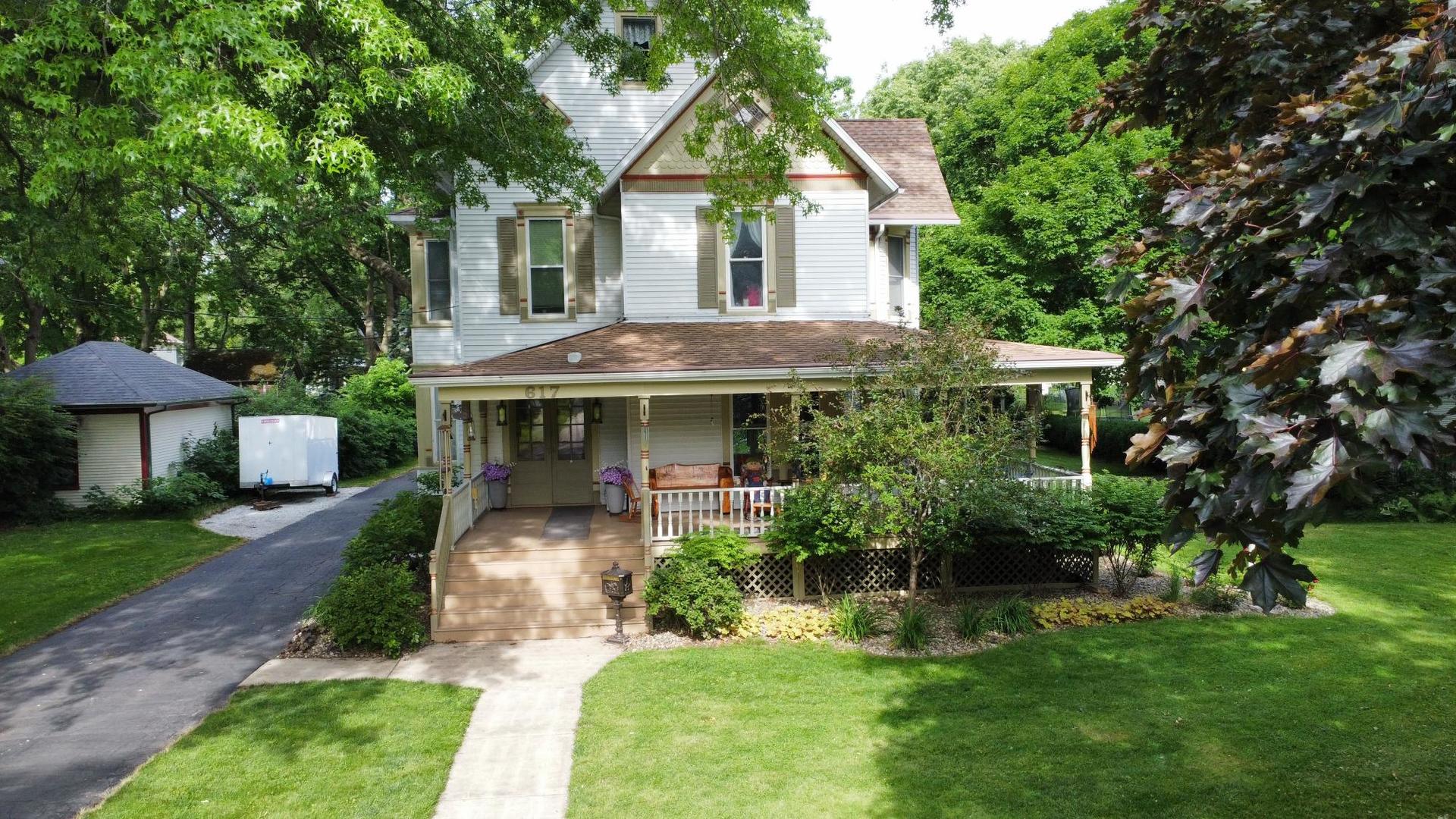 a front view of house with yard and green space