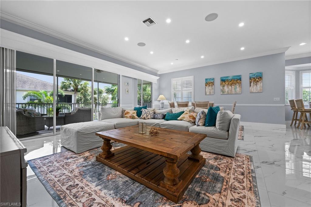 a living room with furniture a rug and a large window