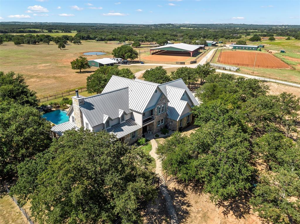 an aerial view of a house with a lake view