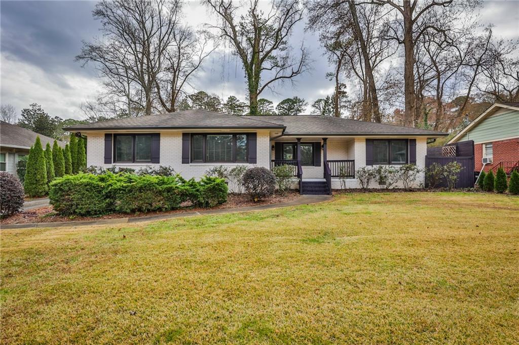 a front view of house with yard and outdoor seating