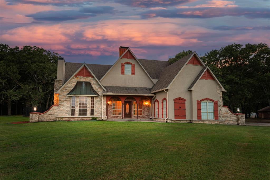 a front view of a house with a garden