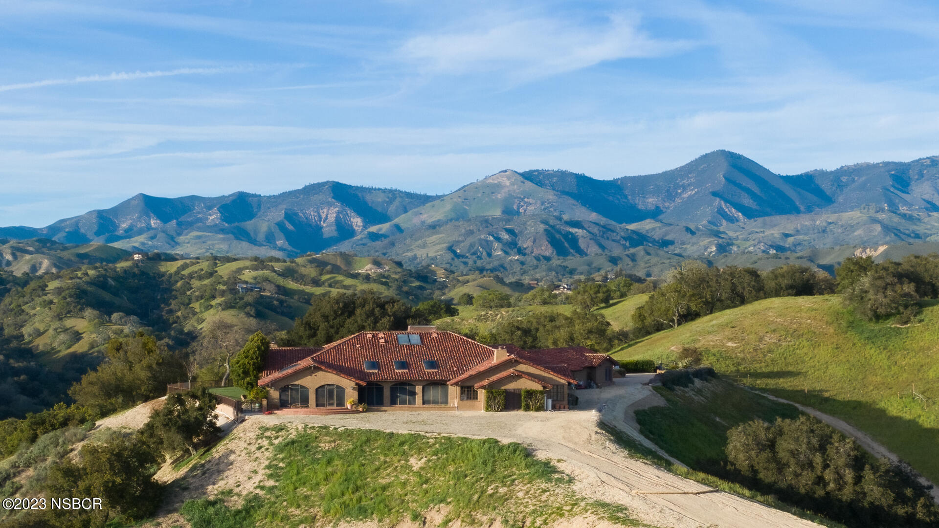 a front view of a house with a mountain