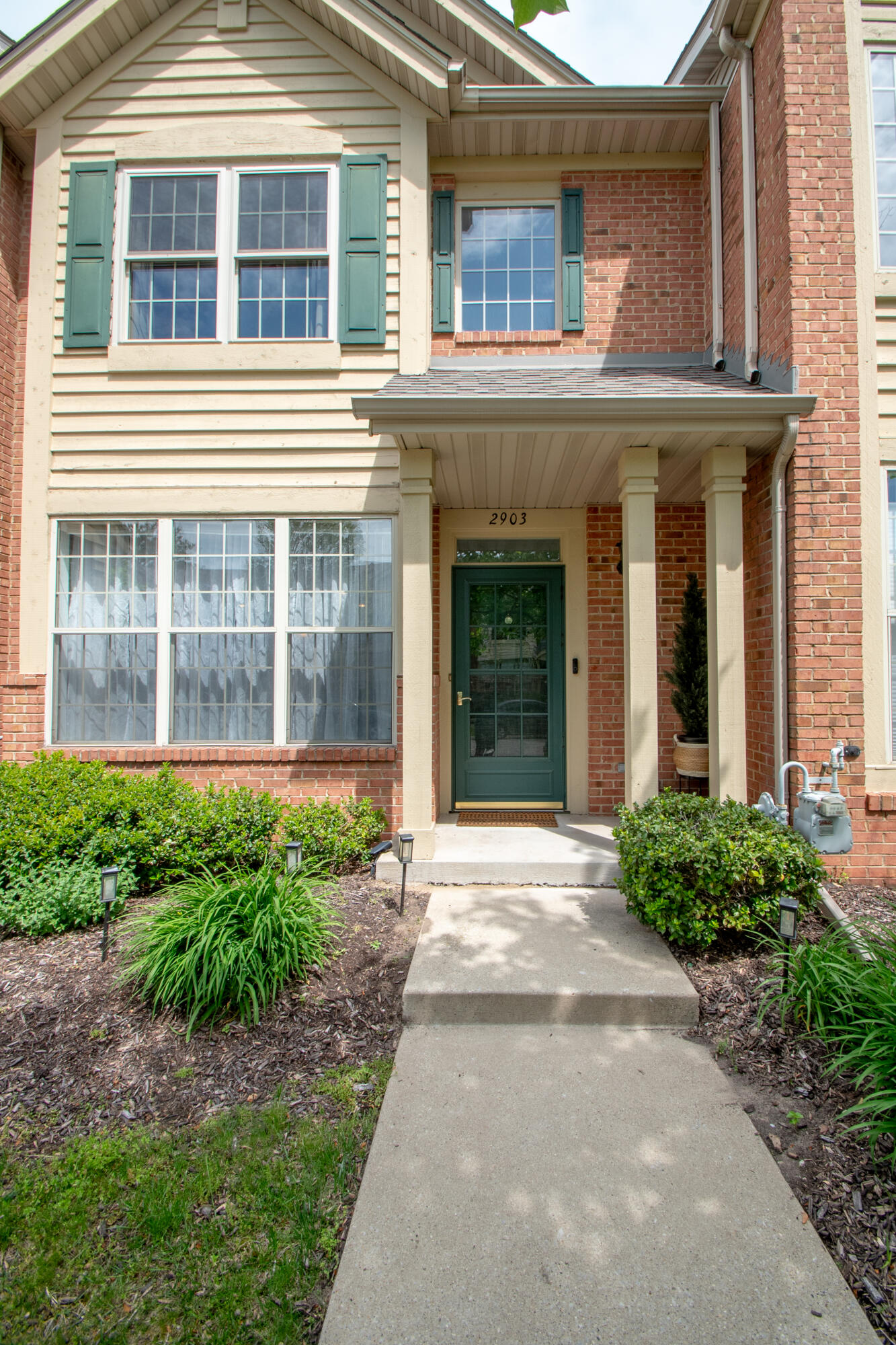 a view of a house with a yard and plants