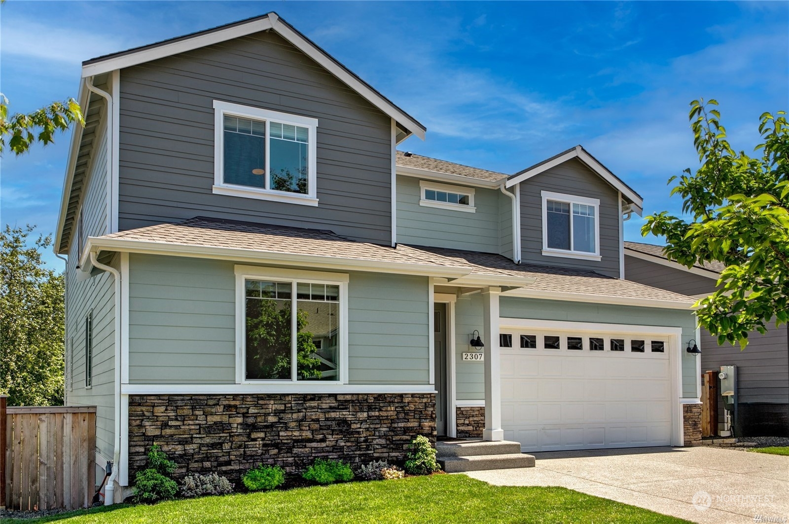 a front view of a house with a yard and garage