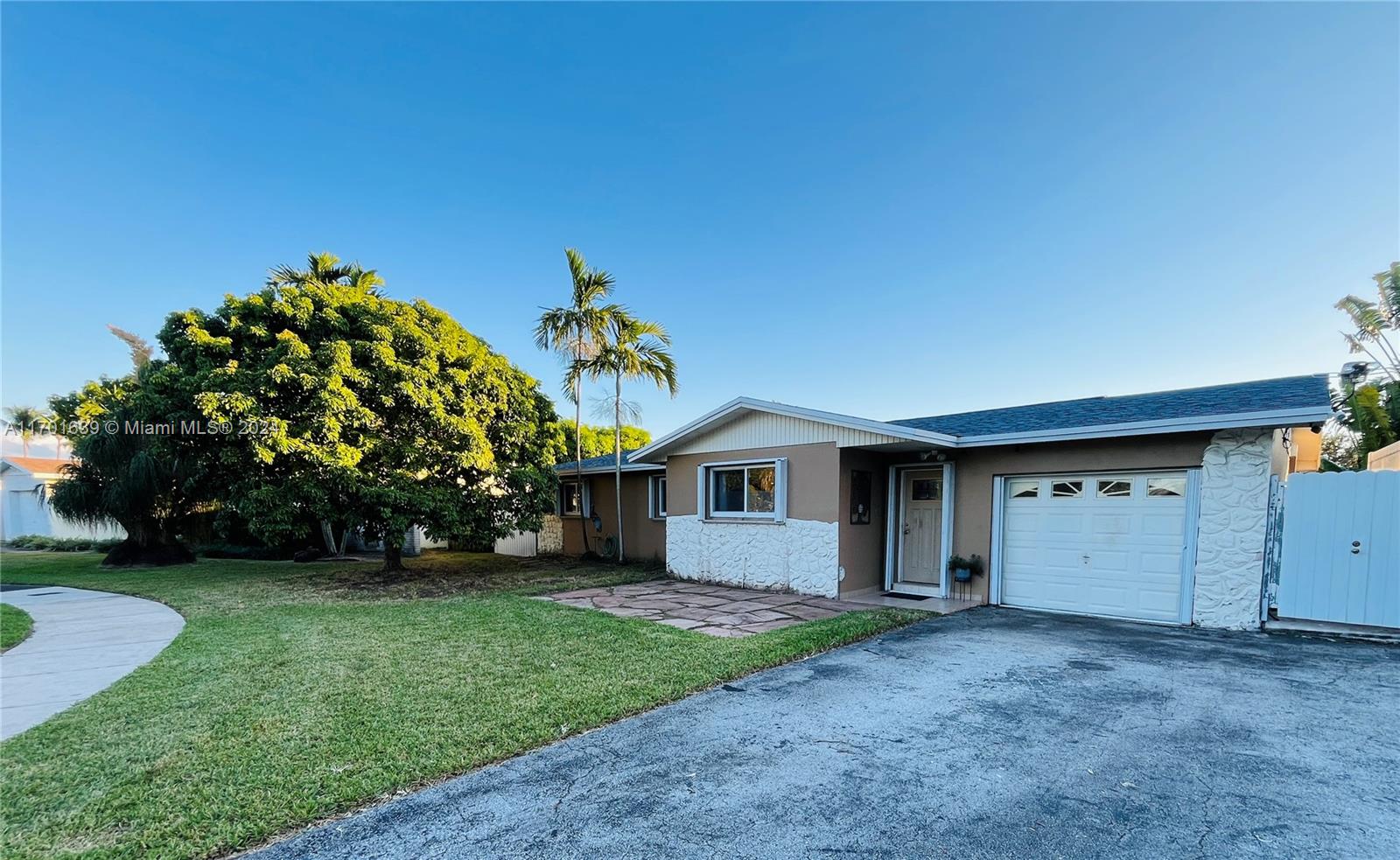 a view of a house with a yard and garage