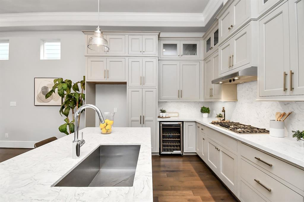 a kitchen with stainless steel appliances granite countertop a stove a sink and white cabinets