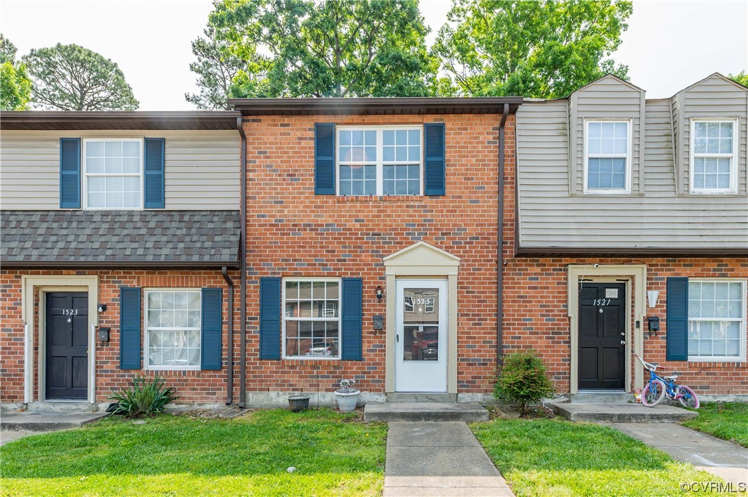 front view of a house next to a yard