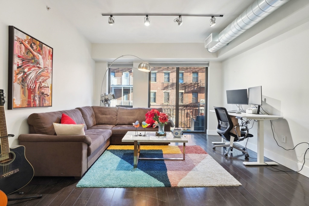 a living room with furniture rug and window