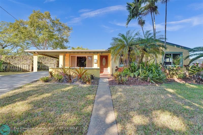 a house with palm tree in front of it