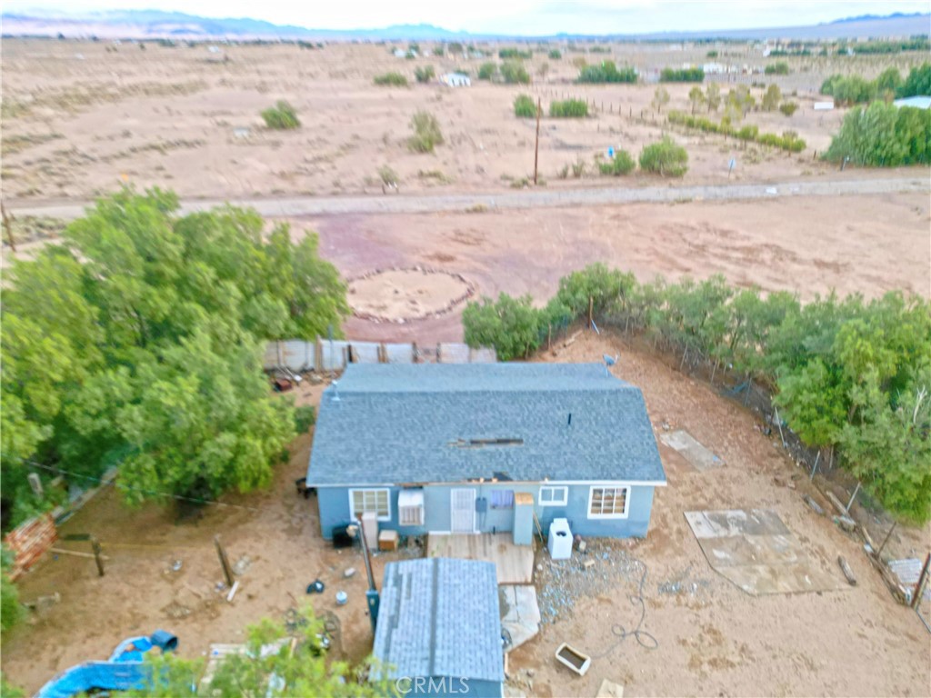 an aerial view of a house with a yard and lake view