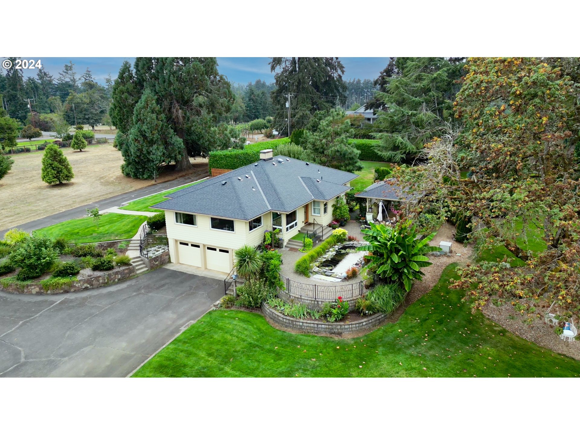 a black and white house with a yard