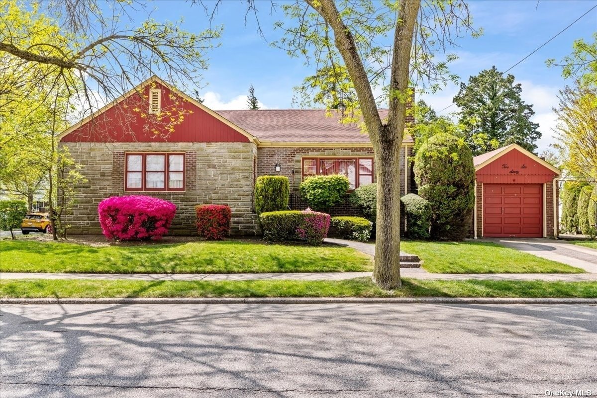 a front view of a house with a yard and garage