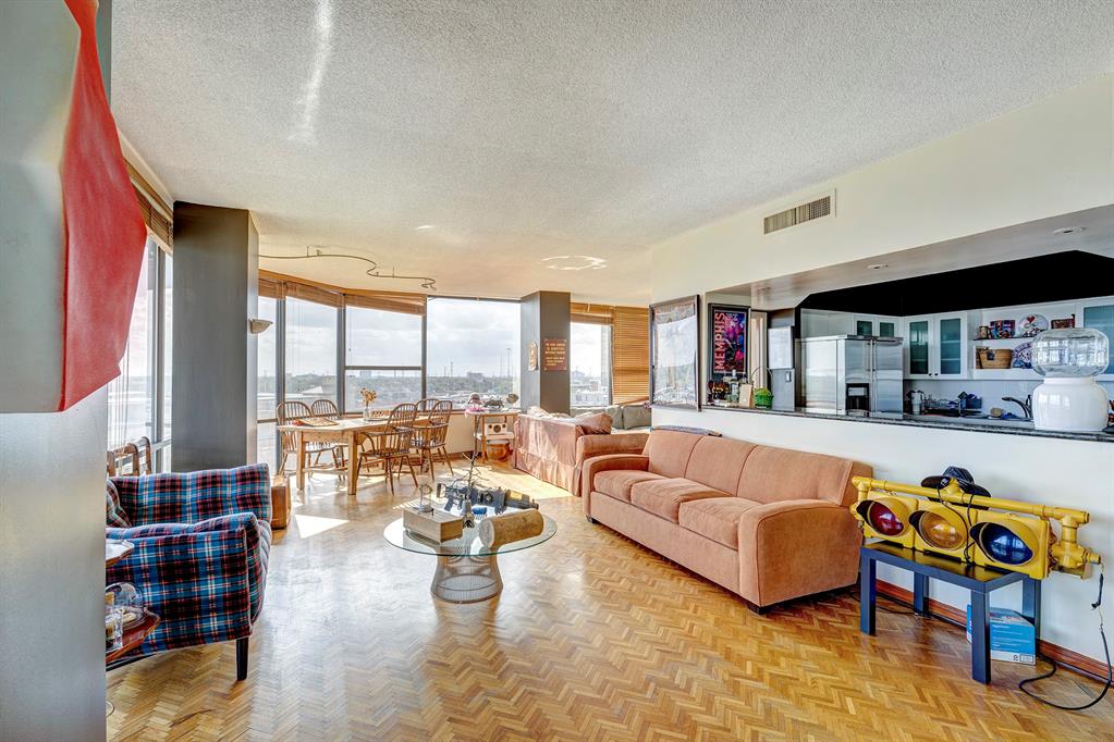 a living room with furniture a rug and a floor to ceiling window