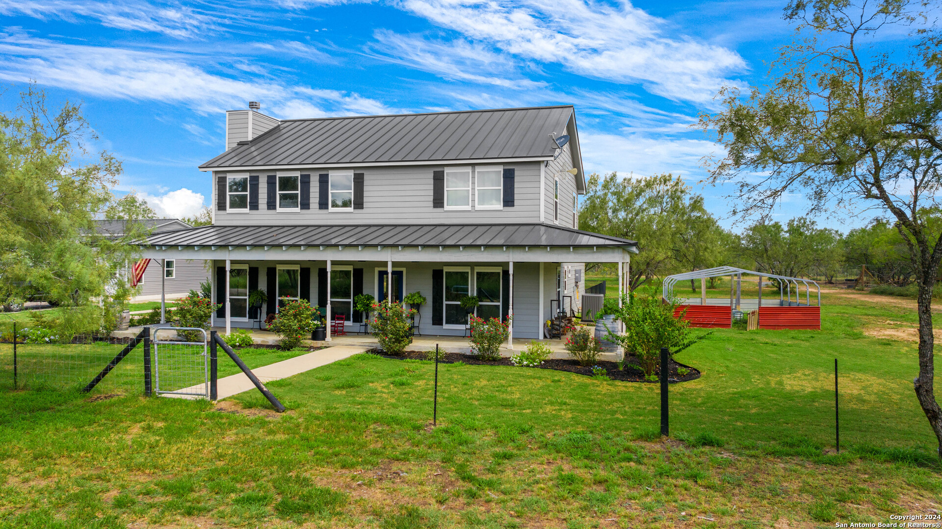 a house view with a sitting space and garden