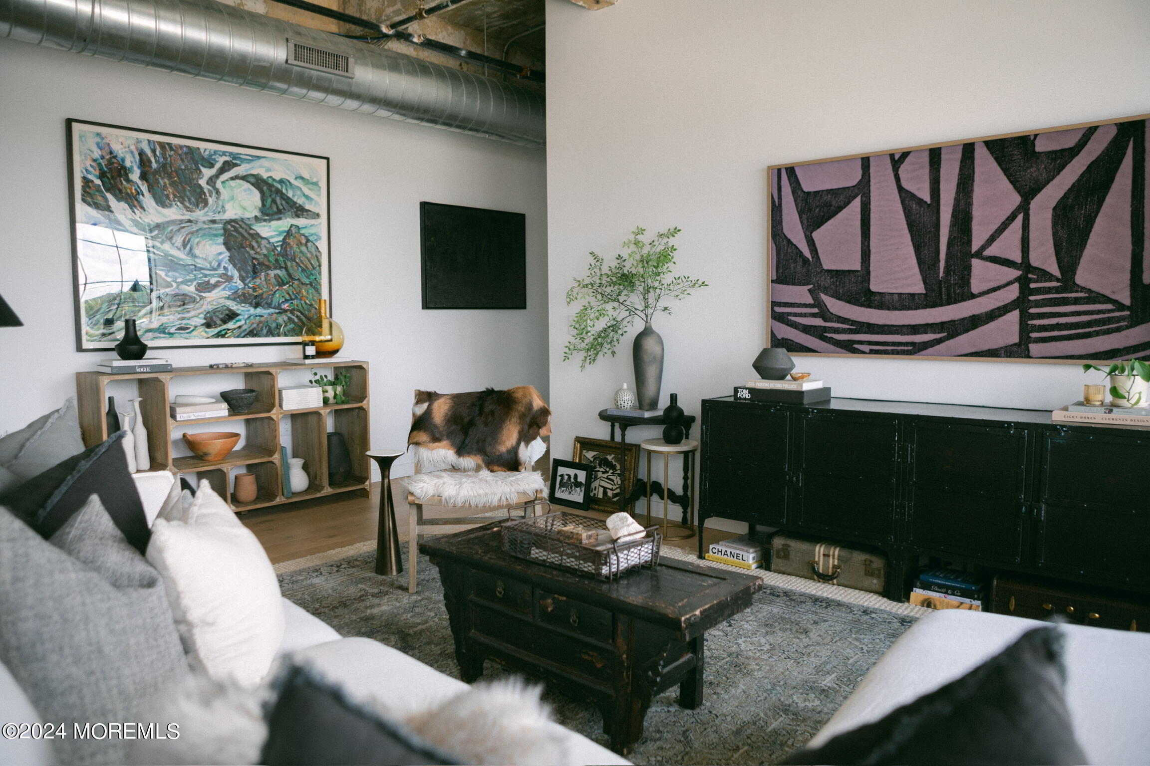 a living room with furniture a flat screen tv and a floor to ceiling window