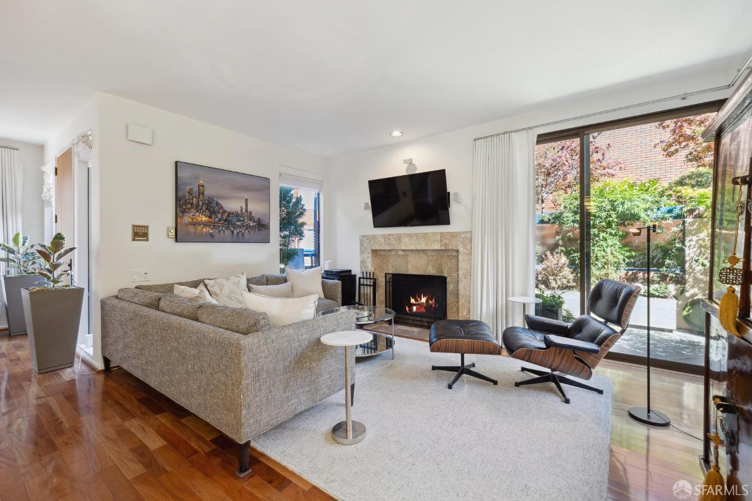 a living room with furniture fireplace and a large window