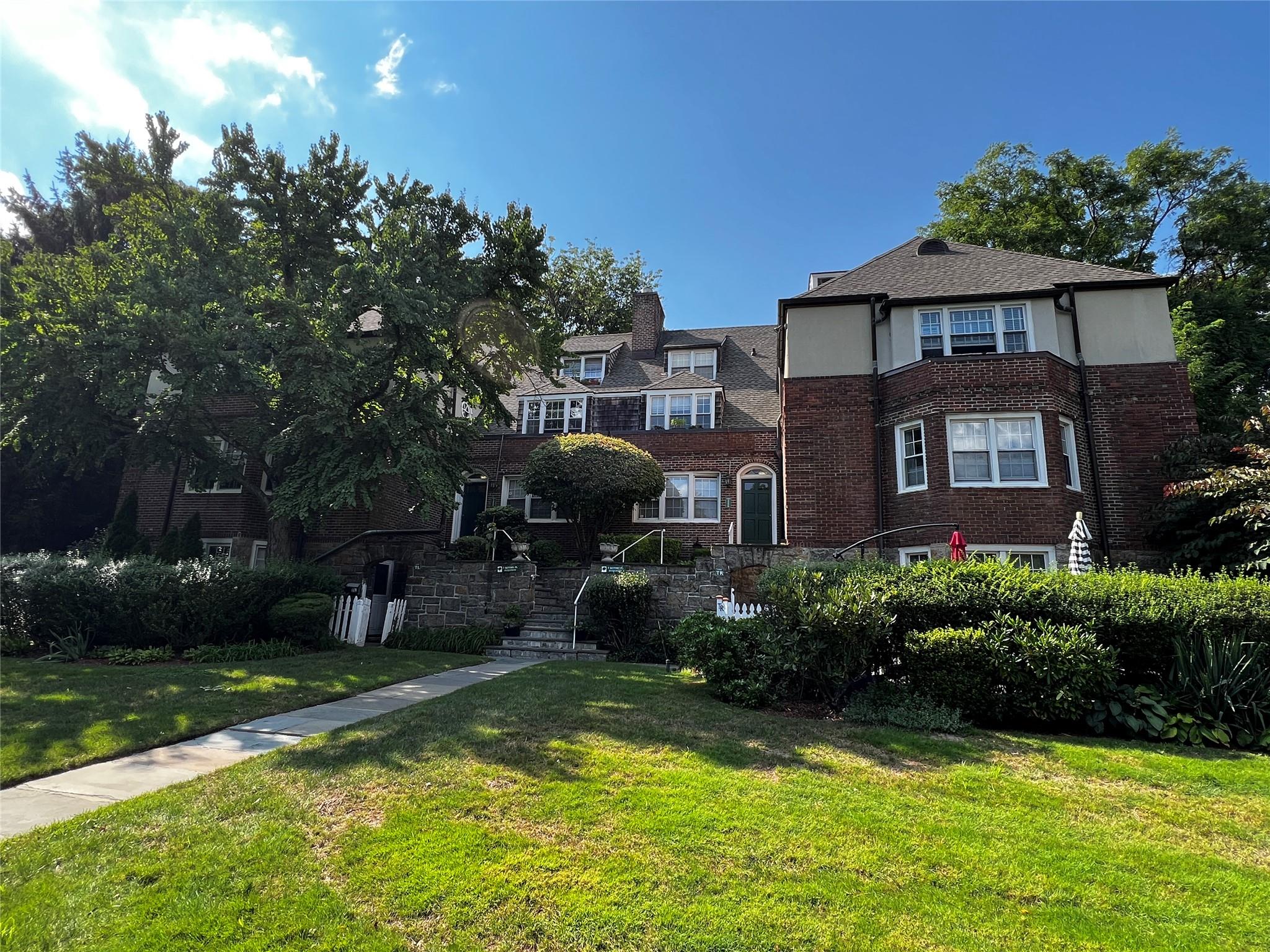 a front view of a house with garden