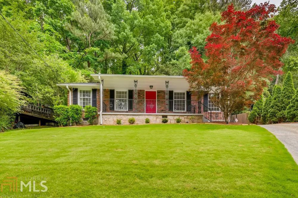 a view of a house with pool and a yard