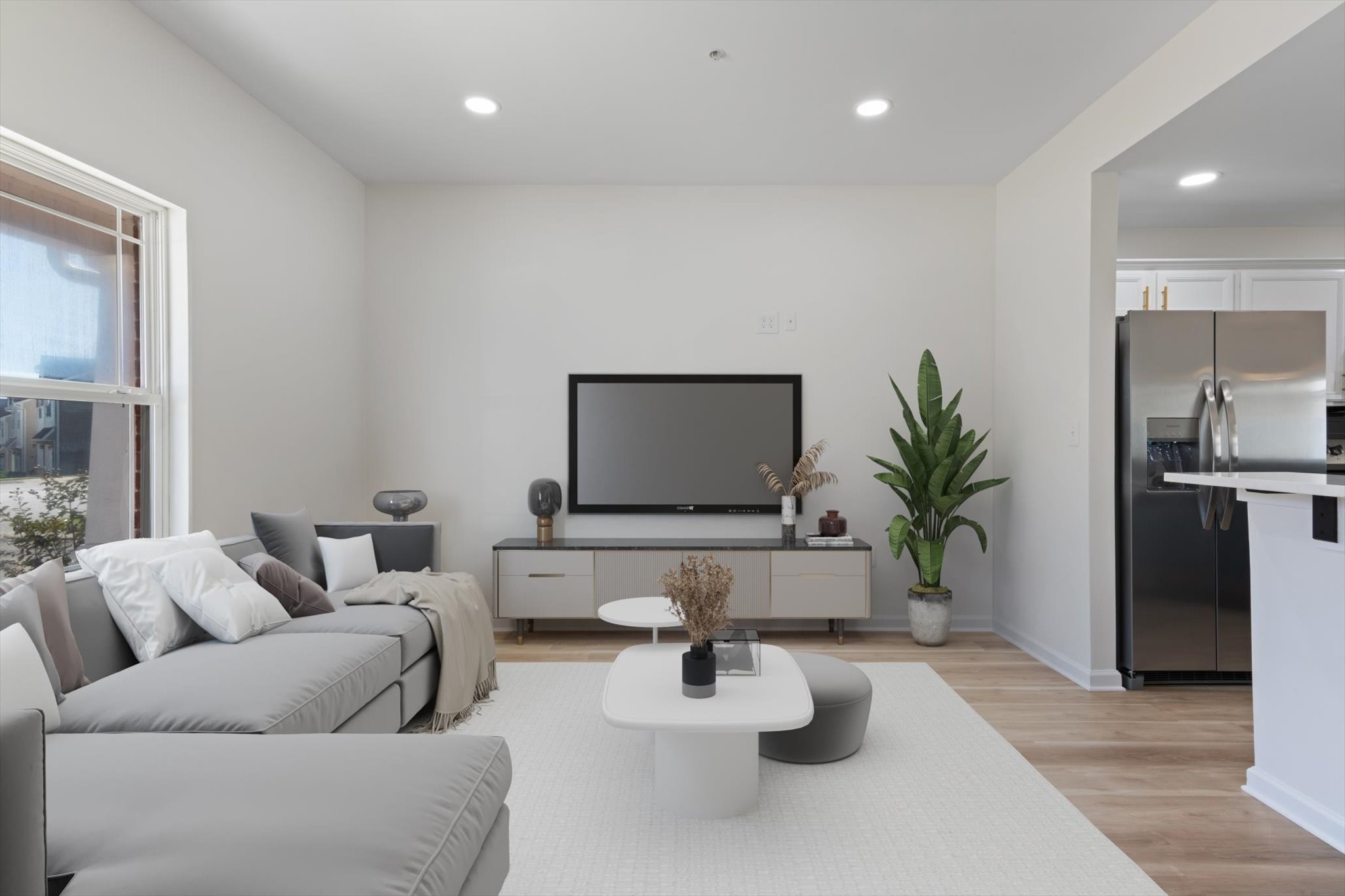 a living room with furniture and a potted plant