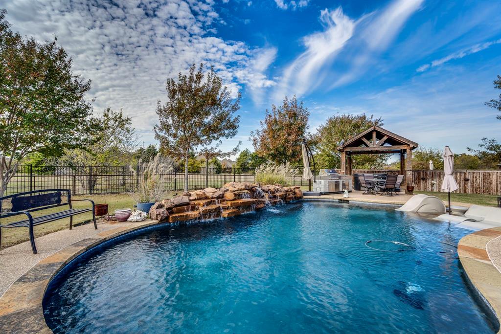 swimming pool view with a seating space