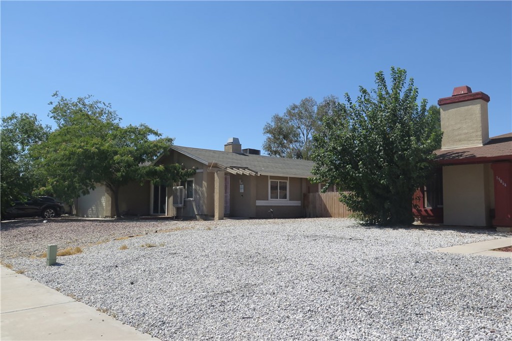 a front view of house with yard and trees