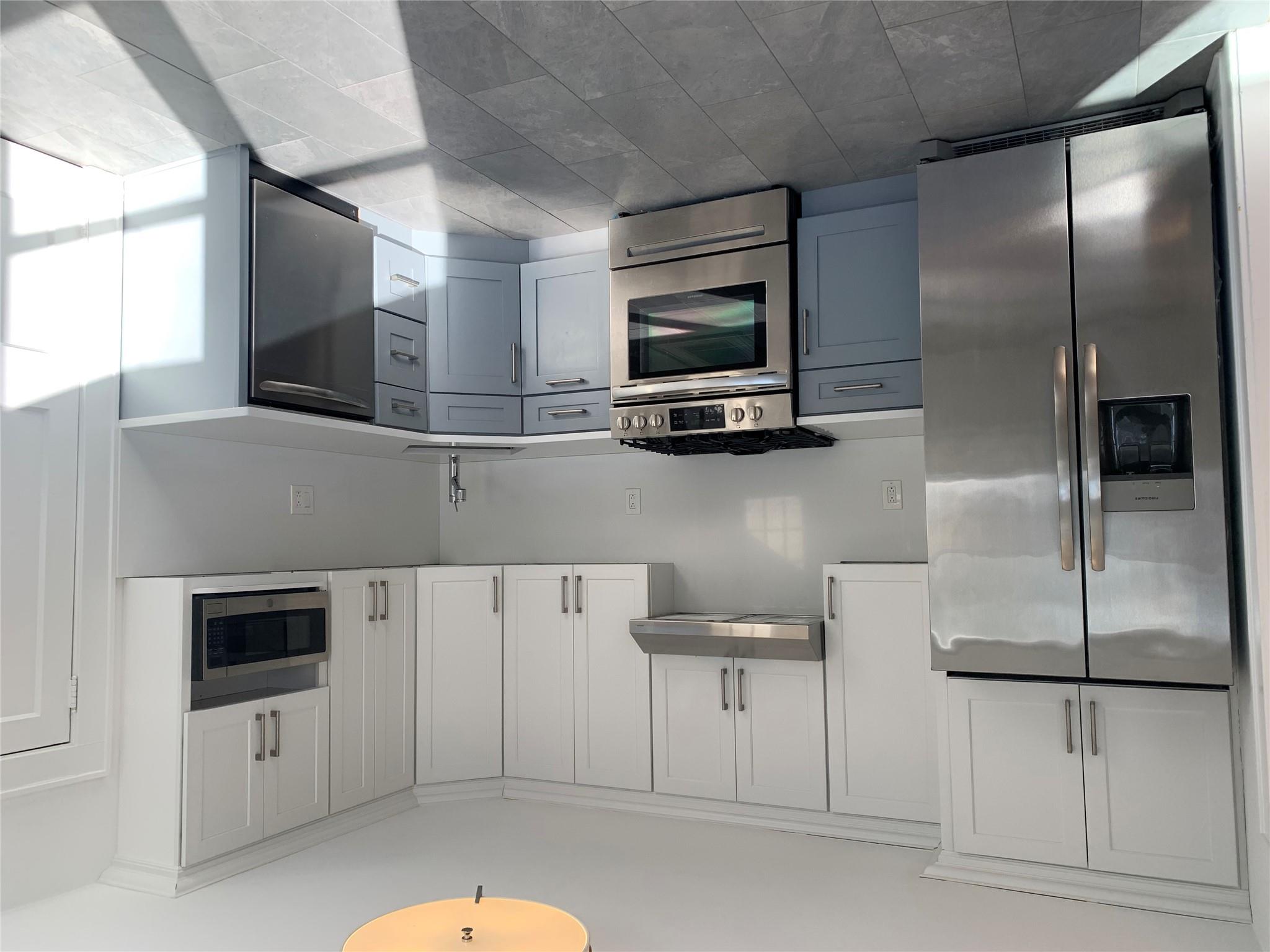 a kitchen with cabinets and stainless steel appliances