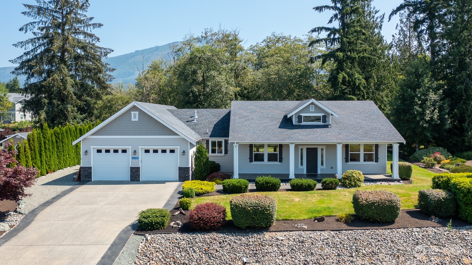 a front view of a house with a garden