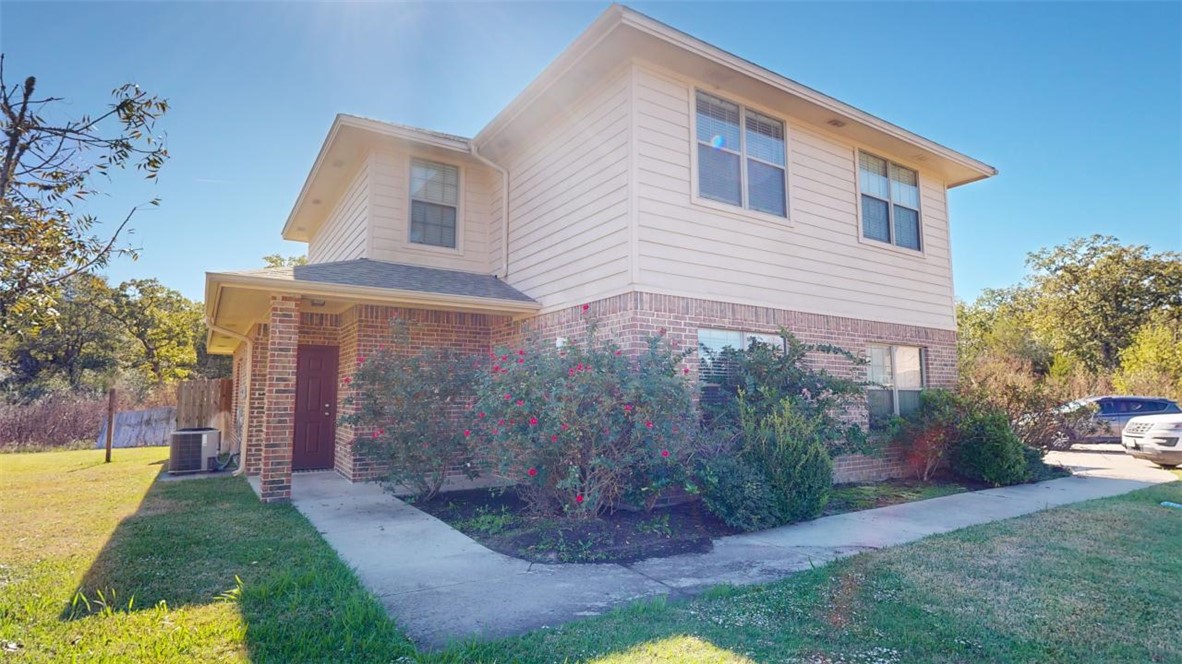 Front of property featuring central AC and a front