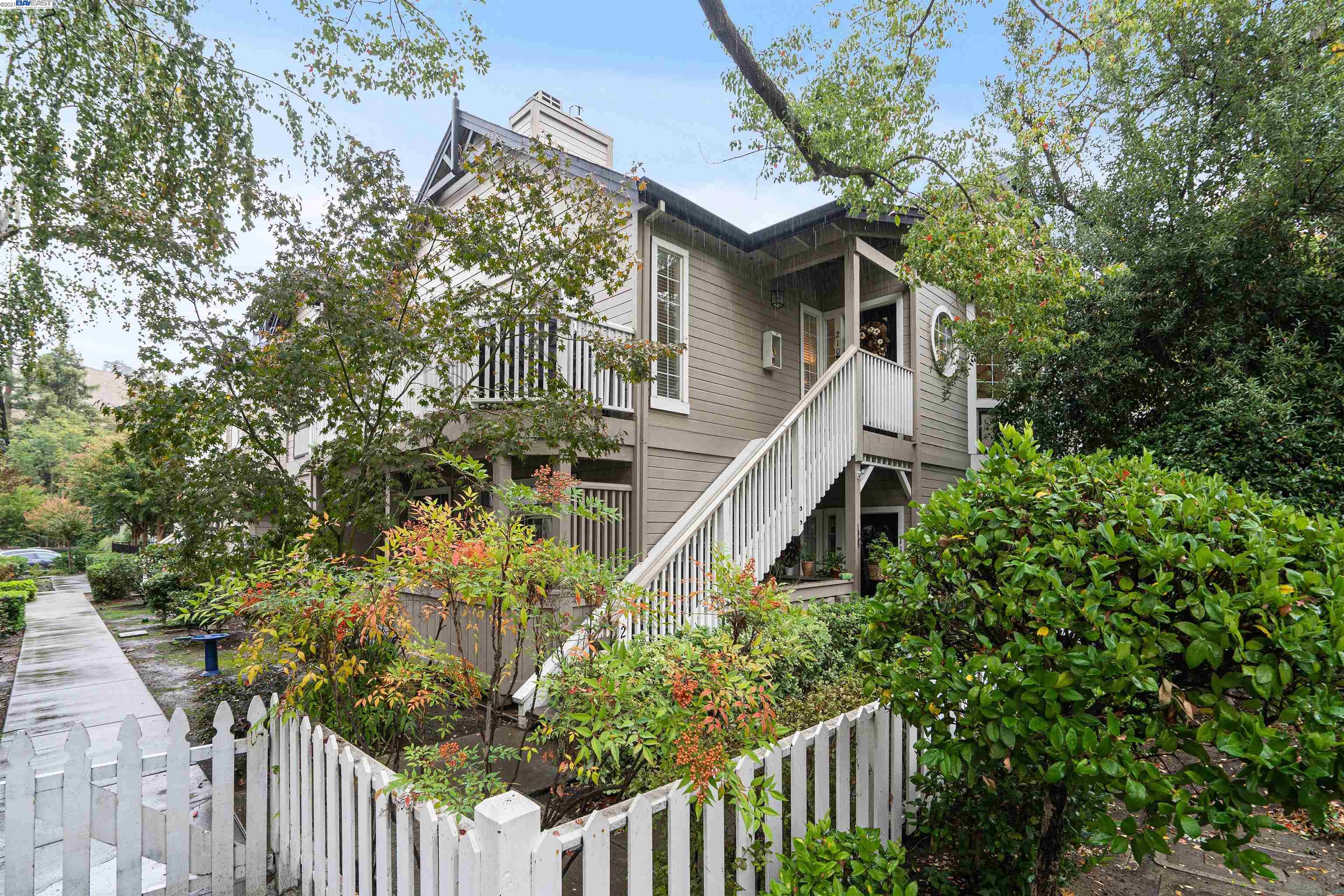 a view of a house with wooden fence and garden