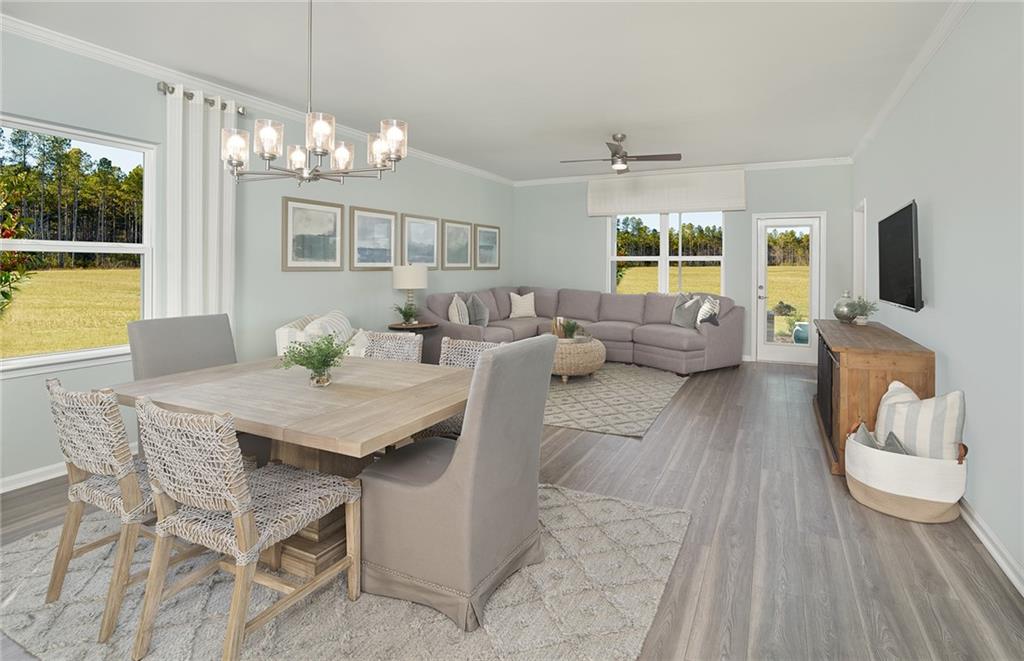 a view of a dining room with furniture a chandelier and wooden floor