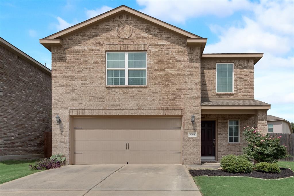 a front view of a house with garage