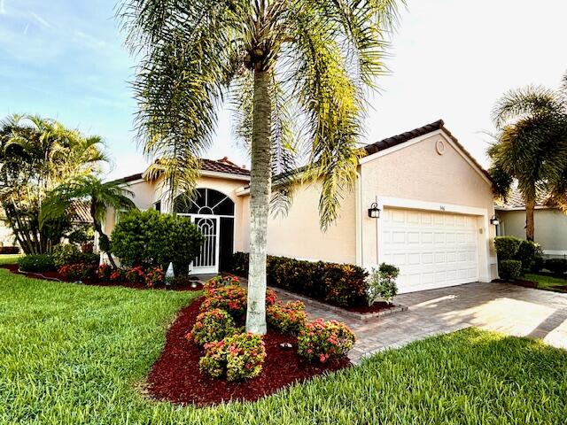 a front view of a house with a yard and garage