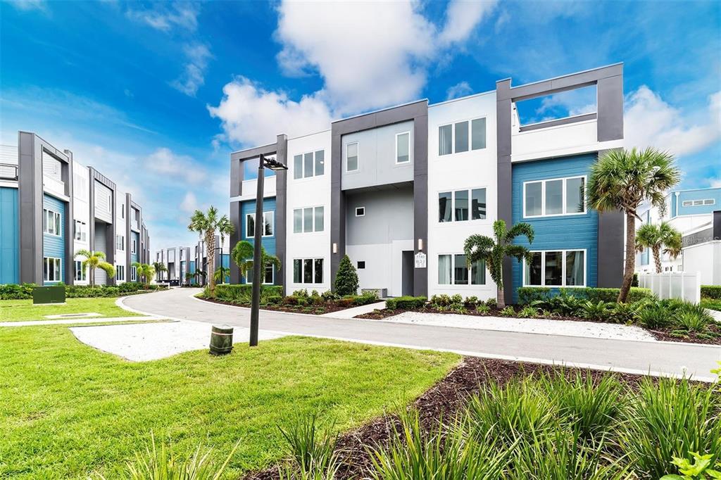 a front view of a residential apartment building with a yard