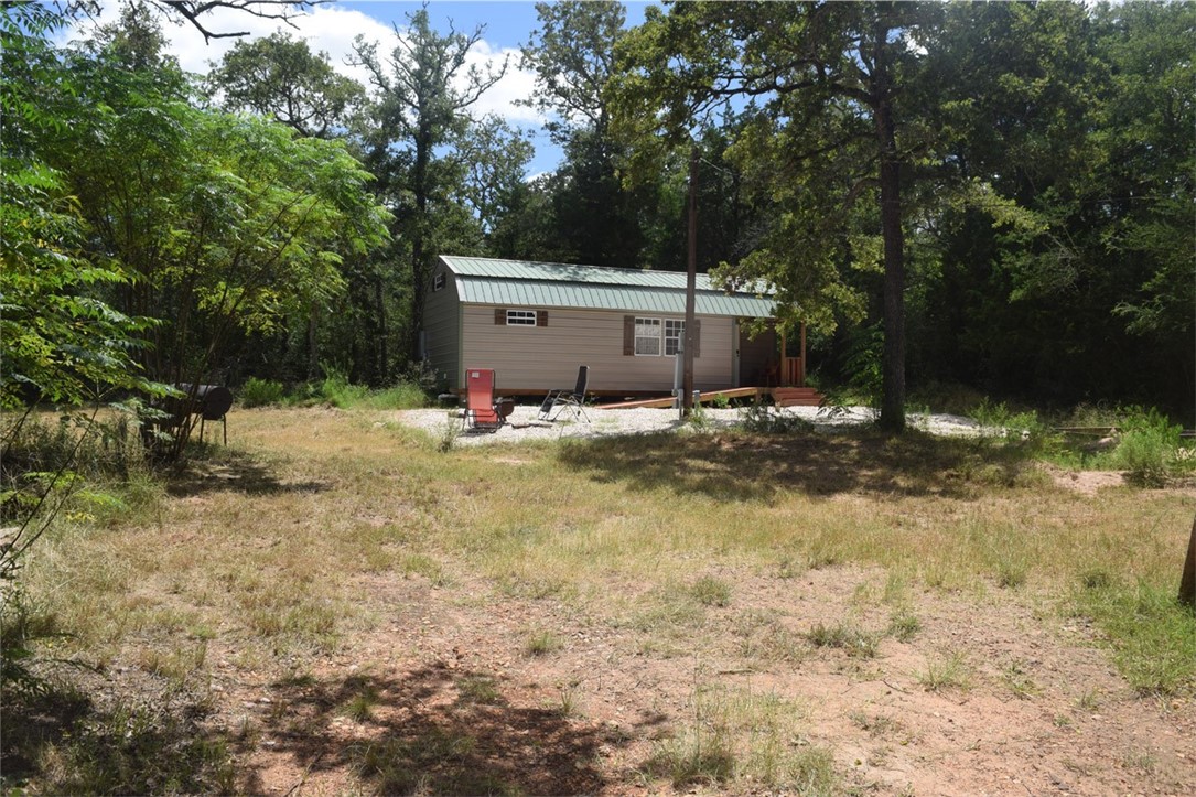 a view of backyard with large trees