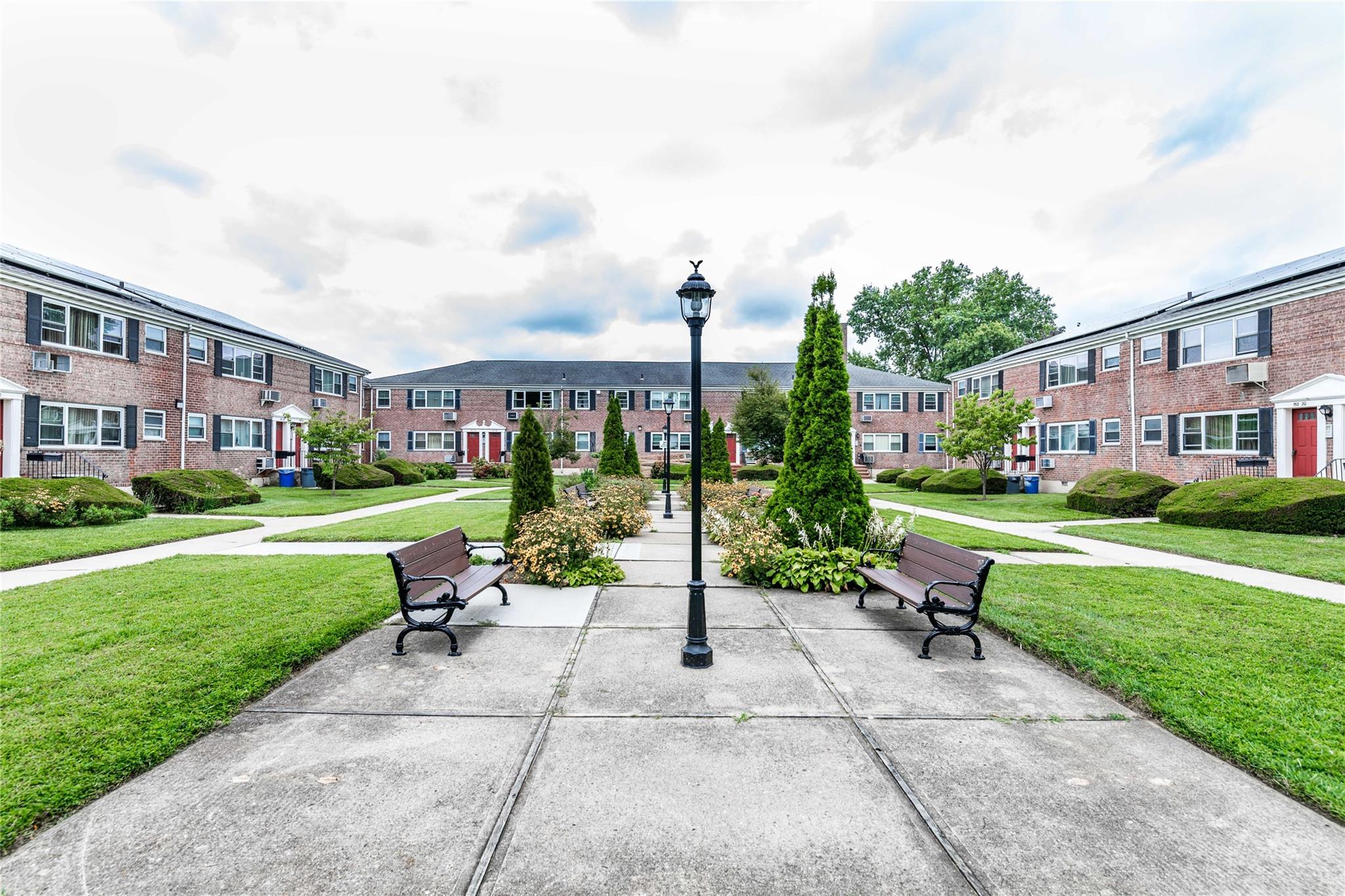 View of home's community with a lawn