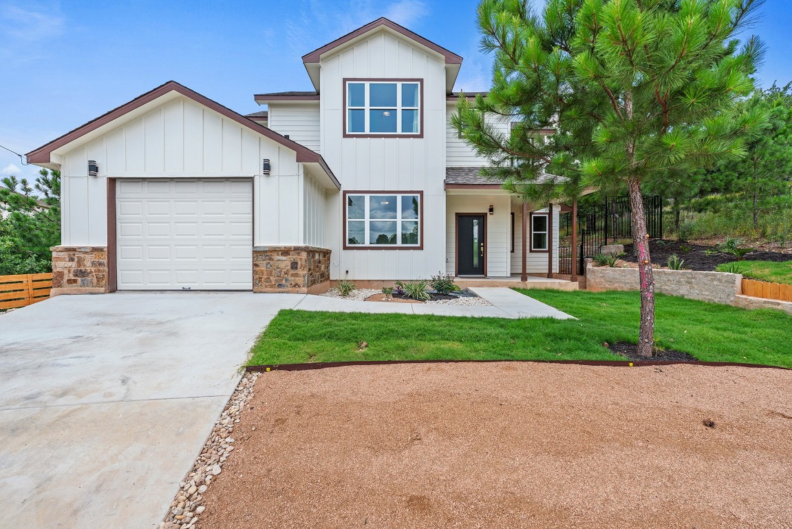 a front view of a house with a yard and garage