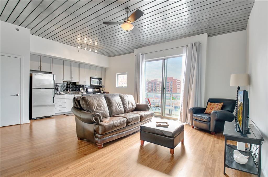 a living room with furniture or kitchen view and a wooden floor