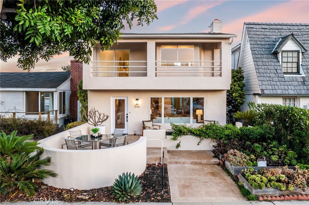 a front view of a house with garden and patio